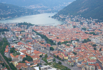 Fototapeta na wymiar Italy, Lombardia, Como, 8/23/2018, aerial view of lake Como and city, Como is a city located in the southern part of Lake Como. It is known for its Gothic cathedral, the panoramic funicularn