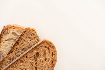 top view of whole wheat bread slices on white background with copy space