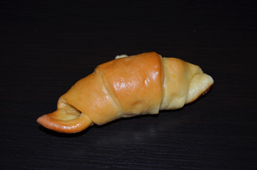 Homemade pastry. Bagel, сroissants on a dark background.