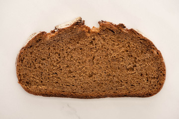 top view of fresh brown bread slice on white background