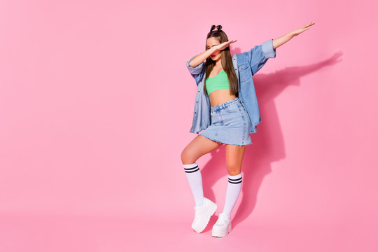 Full length photo of music lover girl enjoy dab dancer perform stage dance wear green denim clothes sneakers isolated over pastel color background