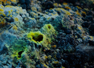 Close up of a mini volcanic fumarole surrounded by delicate sulphur crystals