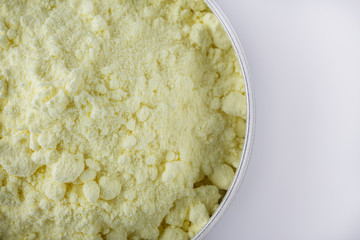 purified sulfur powder on a white acrylic background