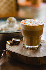 cup of coffee with cream чашка кофе на столе с плиткой шоколада