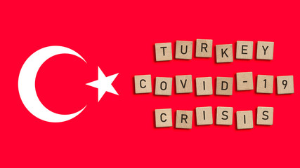 Turkey Covid 19 crisis written with wooden tiles over Turkish flag