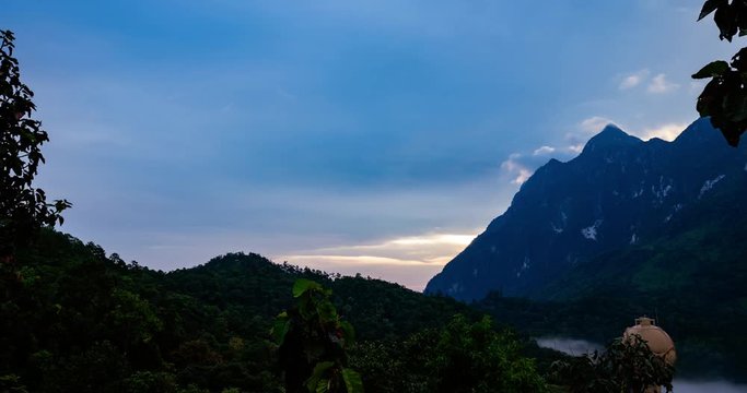 Time lapse Landscape Sunrise with mountain, hill with trees, blue sky with mist.