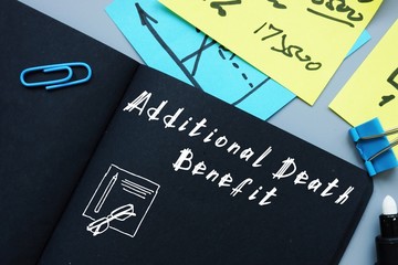 Additional Death Benefit word on notepad on woody desk