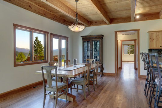 Classic country home in American Cascade mountains dining room interior with antique furniture.