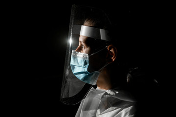 view of young girl in medical mask and protective screen