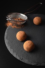 Chocolate truffles on a slate plate