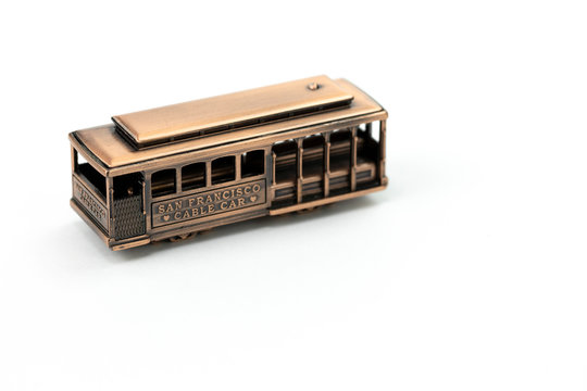 die cast toy san francisco cable car isolated on white background metal model souvenir from USA, travel memory concept, copper tram car figurine, symbol of san francisco copy space