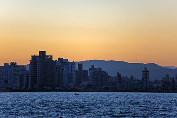 Fototapeta na wymiar Row of buildings on the coast of Florianópolis at sunset, Santa Catarina, Brazil