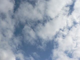 Beautiful blue sky with clouds background. Sky clouds. Air and fluffy clouds in the blue sky on a sunny day, background texture. Copy space for your text.