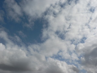 Beautiful blue sky with clouds background. Sky clouds. Air and fluffy clouds in the blue sky on a sunny day, background texture. Copy space for your text.