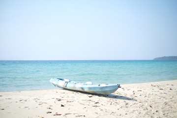 Blue kayaks on the tropical beach.