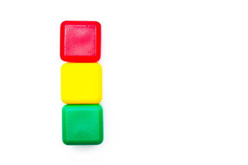 Children toys. Multicolored cubes in a shape of traffic light on white background. Isolated