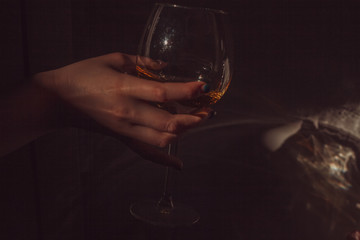 Fototapeta na wymiar a glass of white wine in hand 
