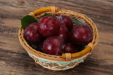 Plum heap in the wooden basket