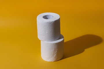 Creative still life with rolls of toilet paper, hot commodity during covid-19 and period of self...