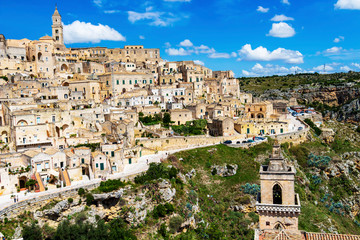 Fototapeta na wymiar Scenic panoramic sunny summer view of Matera, Province of Matera, Basilicata Region, Italy. San Pietro Caveoso bell tower in the foreground