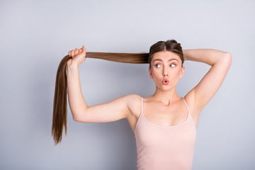 Photo of attractive shocked model lady demonstrating ideal neat long healthy hairstyle making...