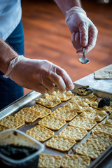 chef makes sandwiches with black caviar