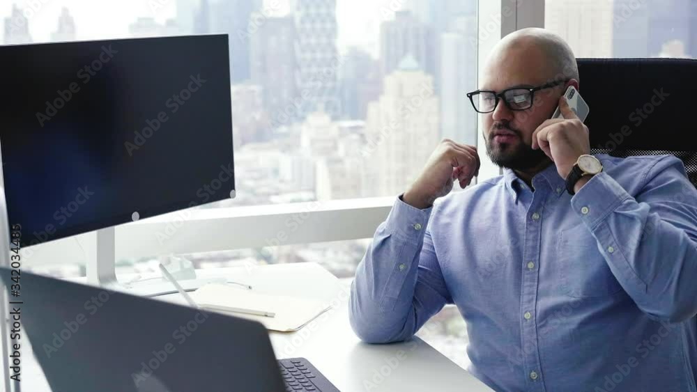 Poster confident businessman in optical spectacles making smartphone conversation with international enterp