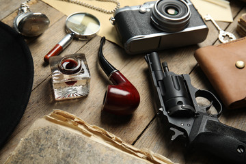 Composition with different vintage items on wooden table. Detective's workplace