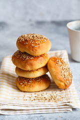 bun buns with sesame seeds on a wooden board.