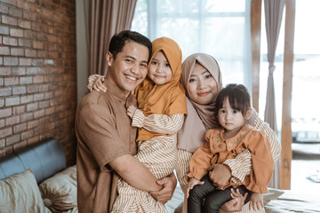 beautiful muslim family smiling to camera. ramadan concept at home