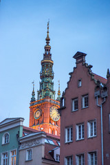 Spire of Gdansk Main Town Hall on background of summer cityscape, Poland 