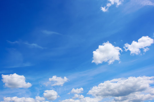 Beautiful blue summer sky with fluffy clouds as a background