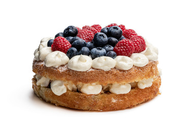 Victoria sponge cake with whipped cream and berries on top isolated on white