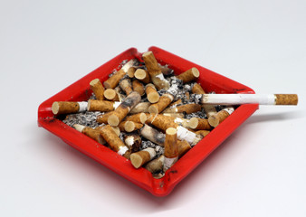 cigarette butt in red ashtray