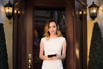 A hostess girl stands with a tablet and greets guests