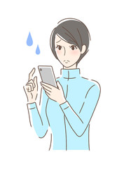 スマホを操作して不安な女性