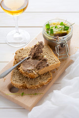 Homemade chicken liver pate on bread on white rustic background. Healthy eating concept. Selective focus