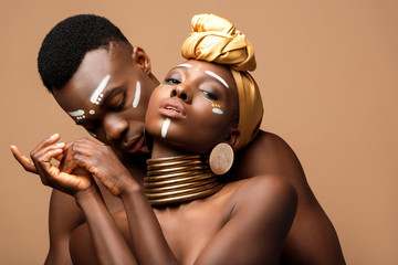 sexy naked tribal afro couple posing isolated on beige