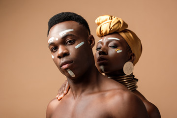 sexy naked tribal afro couple posing on beige