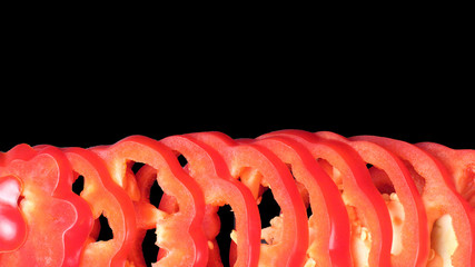 Sliced sweet bell pepper close-up on a black background, isolate, flat lay, top view, copy space.