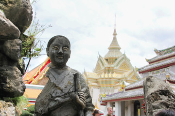 Fototapeta premium Stone Buddha in front of a background temple in Bangkok