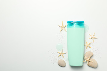 Blank cosmetic bottle and starfishes on white background