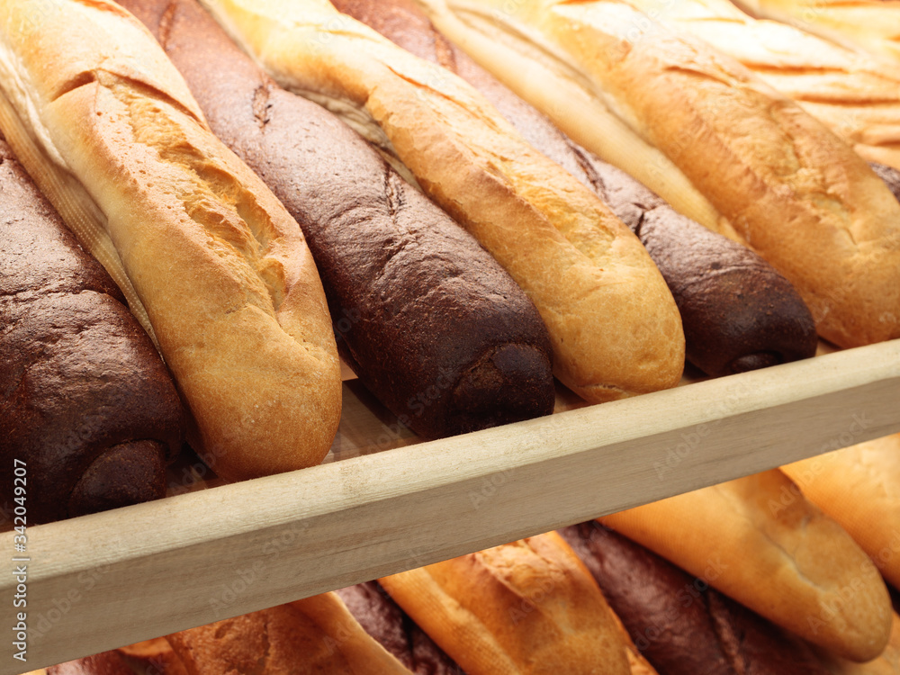 Poster fresh breads on the shelf in the bakery