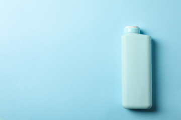 Blank shampoo bottle on blue background, space for text