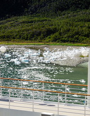 Ice floes broken off glacier in water in bay inside Glacier Alley in Patagonia seen from cruiseship...