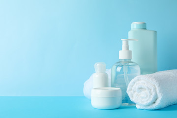 Obraz na płótnie Canvas Body care products on blue background. Personal hygiene