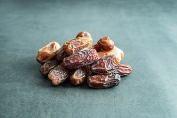 Raw date fruit ready to eat on concrete background. Traditional, delicious and healthy ramadan food.