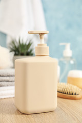 Obraz na płótnie Canvas Bottle for liquid soap on wooden table. Personal hygiene concept