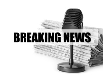 Phrase Breaking News and vintage microphone on white background. Journalist's work