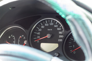 Car dashboard with speedometer and fuel level gauge. Closeup view. Selective focus